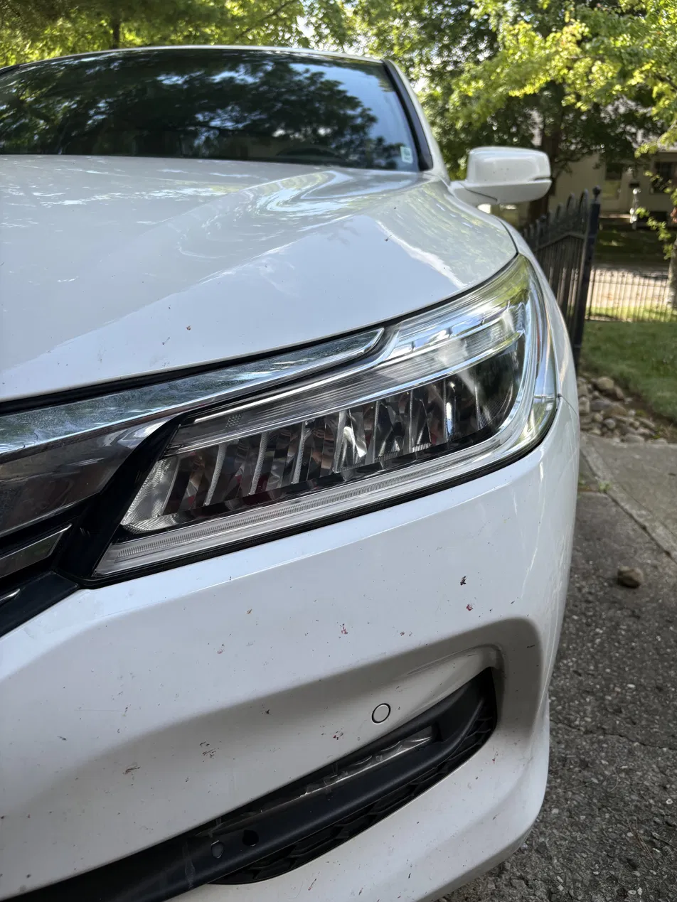Clear, glossy restored headlight lens with tape removed